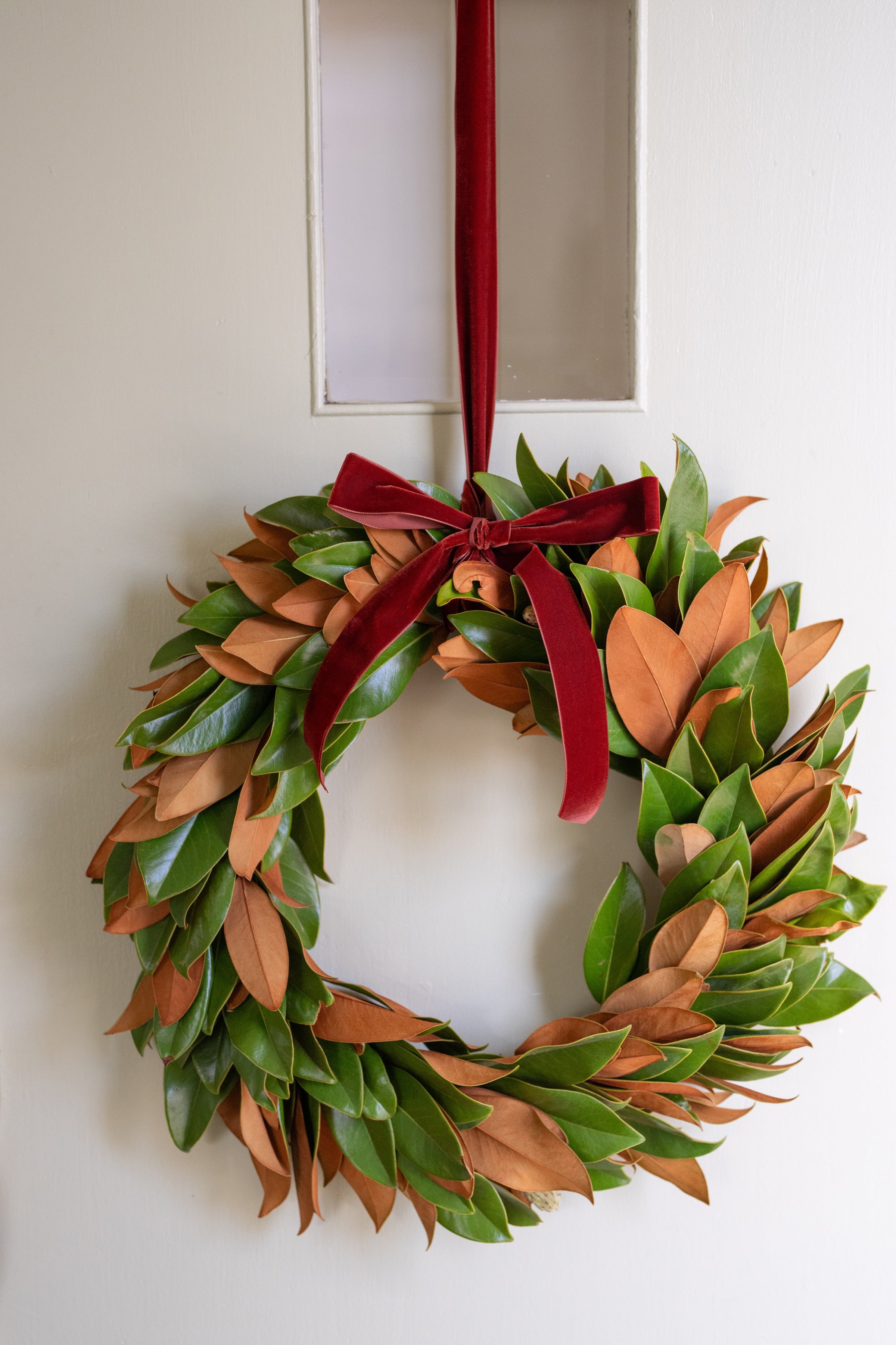 Magnolia wreath with velvet ribbon, handcrafted in California by Matilda’s Flower Market. Farm fresh, American grown, and shipped nationwide.